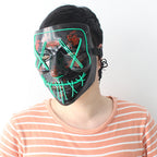 Person wearing a black LED mask with green lights.