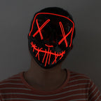 Person wearing a glowing red LED mask with a dark background.