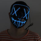Person wearing a black mask with blue LED lights.