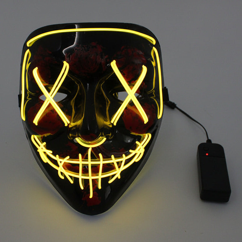 Black mask with yellow LED lights and a power adapter on a gray background.