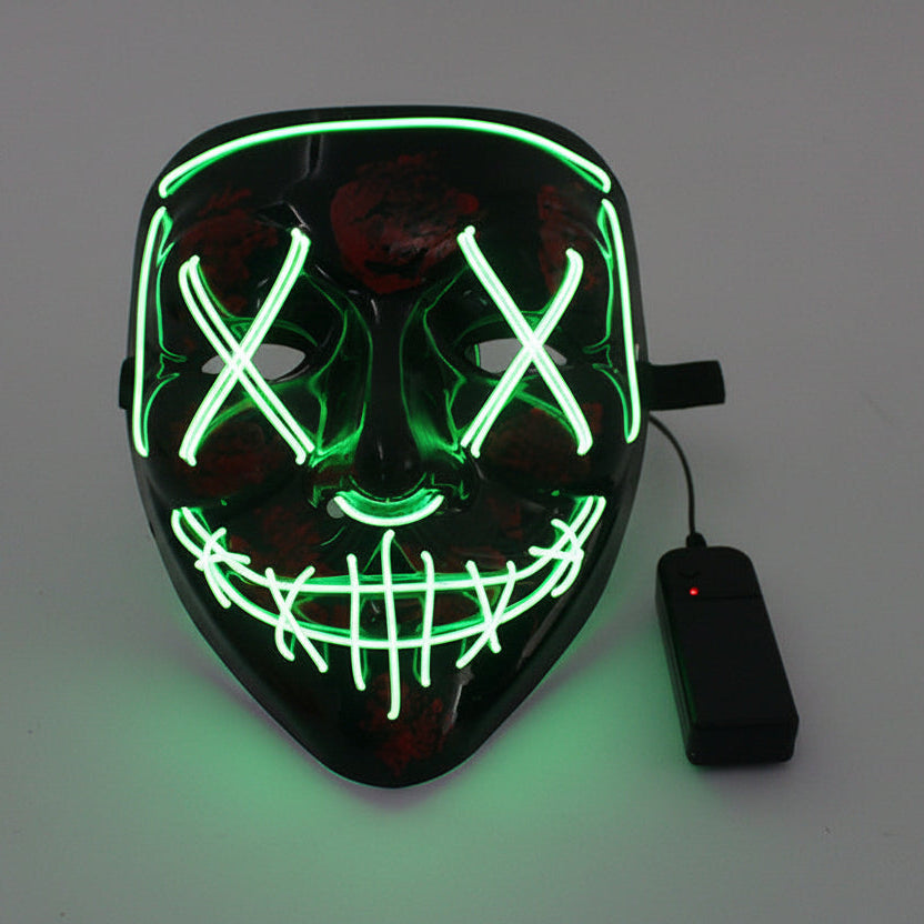 Luminous mask with green LED lights and power adapter on a gray background