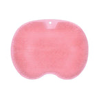 A pink silicone bath sponge with a textured, dimpled surface and a small hanging hole at the top, shown on a plain white background.