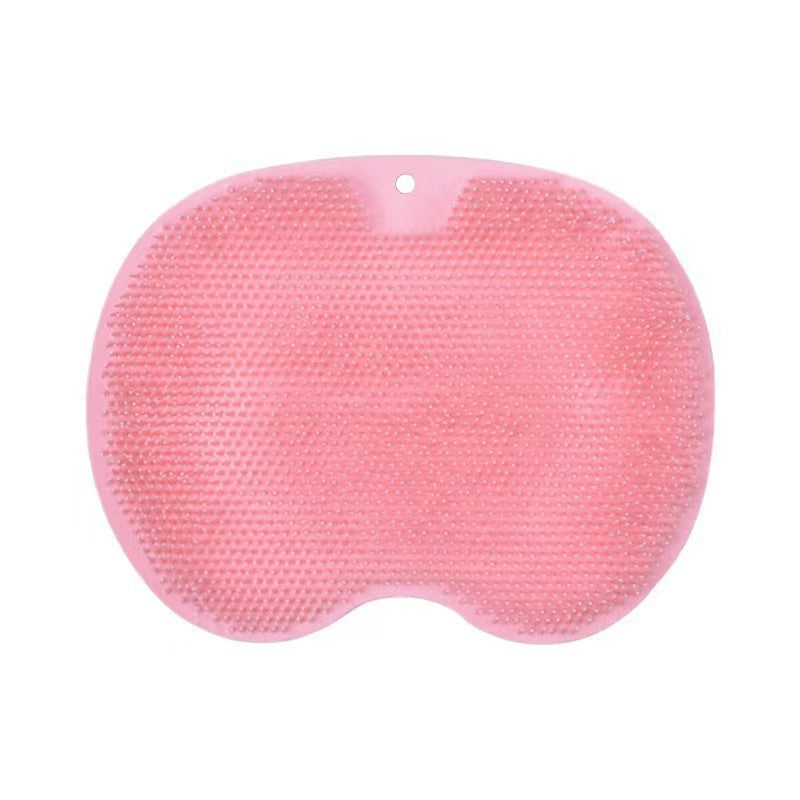 A pink silicone bath sponge with a textured, dimpled surface and a small hanging hole at the top, shown on a plain white background.